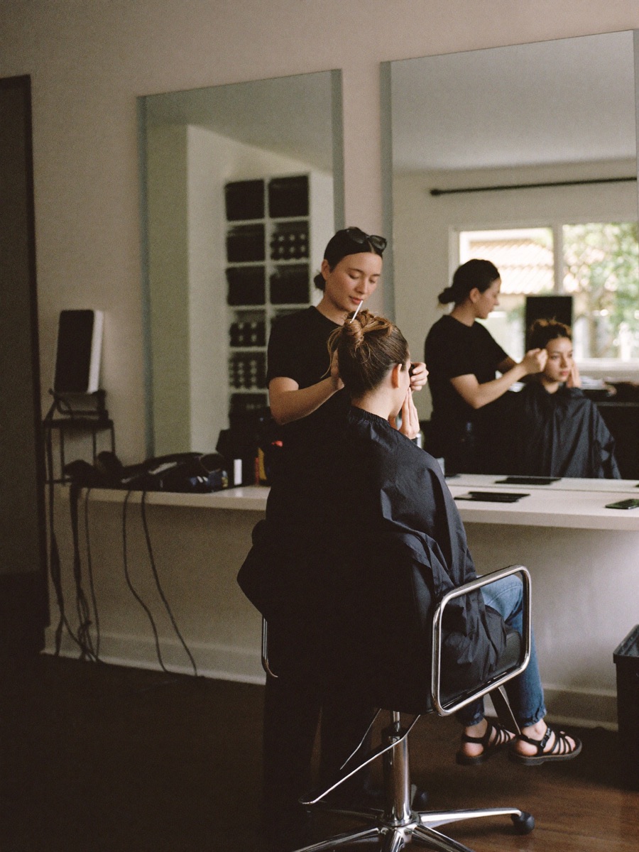 Stylist with a client in a bright salon
