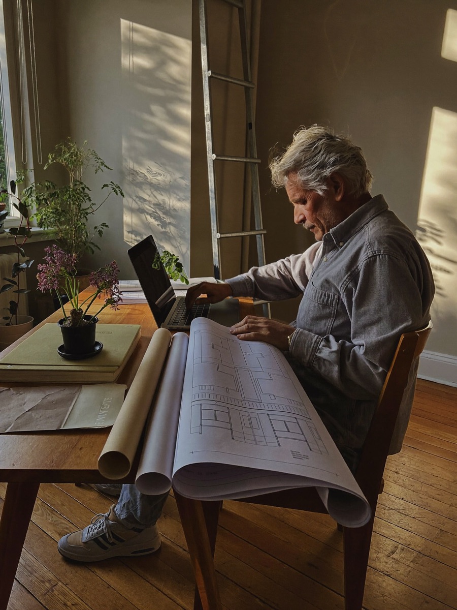 Architect reviewing blueprints at a desk