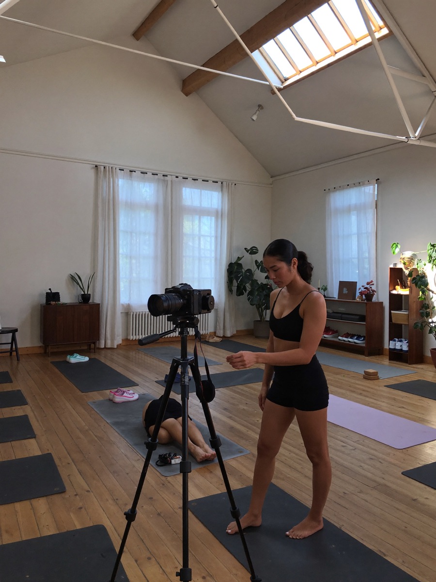 Yoga instructor recording a class in a loft