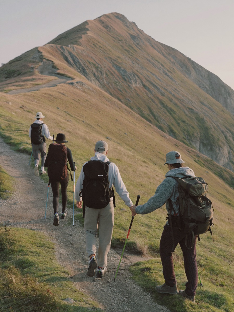 Hiking guides leading a group along a ridge at golden hour